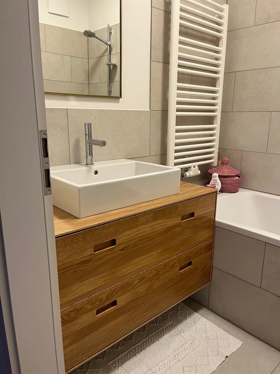 The second washstand in the same flat: oak carcase with two drawers and a continuous oak top running up to the bath.